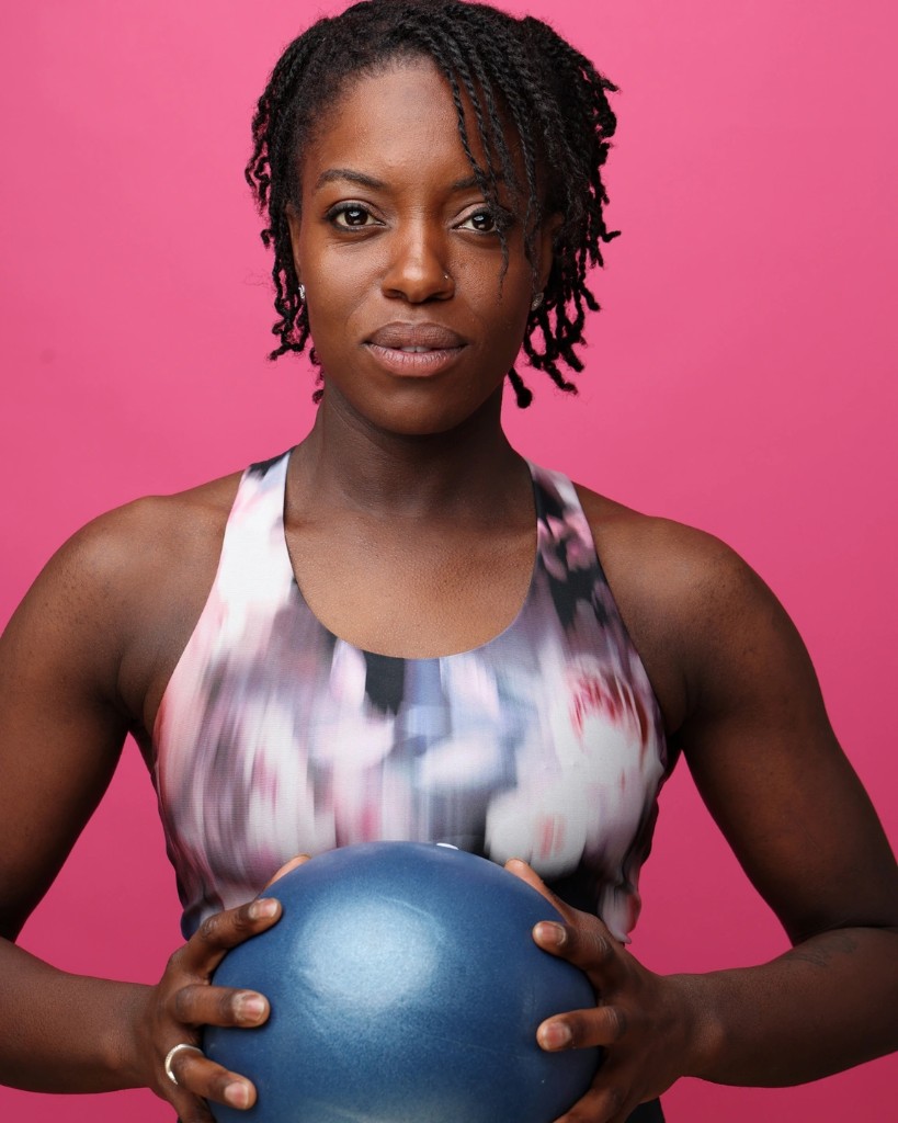 Monique Smith-McDowell holding a Pilates ball